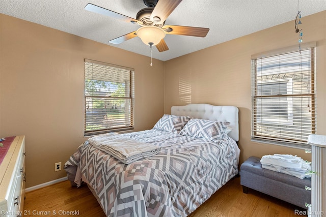 17729 Harman St, Melvindale, MI 48122 - bedroom with wood finished floors, a textured ceiling, and a ceiling fan