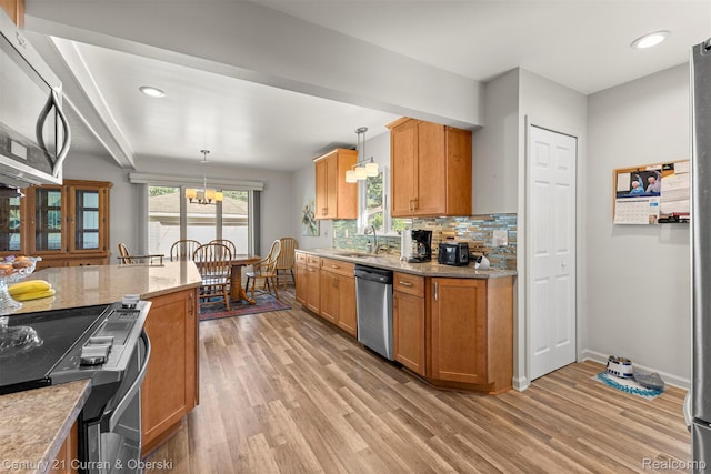 17729 Harman St, Melvindale, MI 48122 - kitchen featuring stainless steel appliances, light wood-type flooring, tasteful backsplash, pendant lighting, and recessed lighting