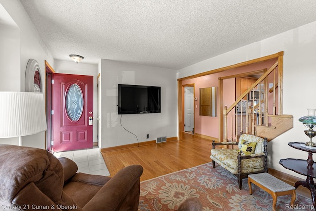 17729 Harman St, Melvindale, MI 48122 - tiled living room with a textured ceiling and stairs