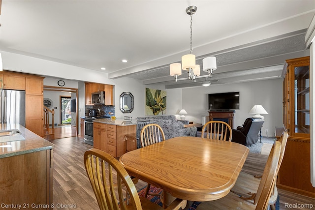 17729 Harman St, Melvindale, MI 48122 - dining space featuring dark wood-style floors, a chandelier, recessed lighting, and beamed ceiling