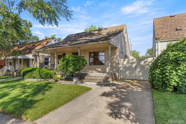 17729 Harman St, Melvindale, MI 48122 - view of front facade featuring a front yard, a porch, and concrete driveway