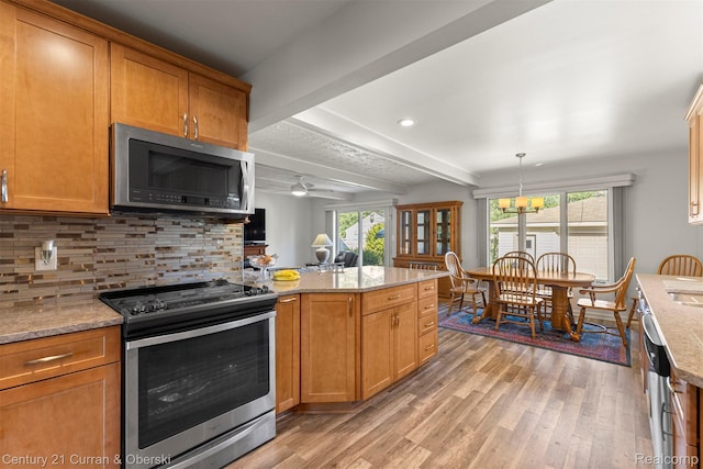 17729 Harman St, Melvindale, MI 48122 - kitchen with appliances with stainless steel finishes, light wood-type flooring, plenty of natural light, beamed ceiling, and recessed lighting