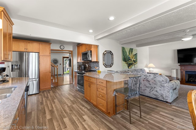 17729 Harman St, Melvindale, MI 48122 - kitchen with stainless steel appliances, open floor plan, wood finished floors, light stone countertops, and recessed lighting