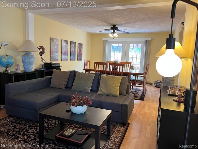 38443 Meghan Ln, Westland, MI 48185 - living room with a ceiling fan, a textured ceiling, and light wood-style flooring