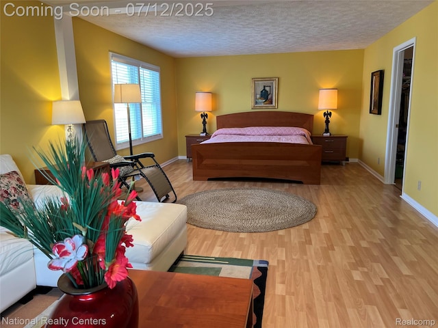 38443 Meghan Ln, Westland, MI 48185 - bedroom with light wood-type flooring and a textured ceiling