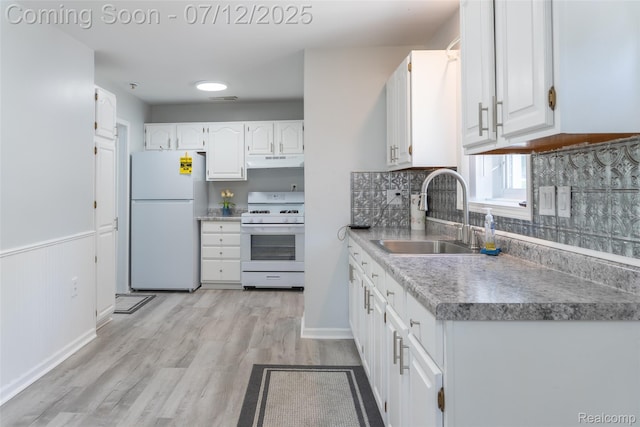 14778 Harrison St, Livonia, MI 48154 - kitchen featuring white appliances, under cabinet range hood, white cabinetry, and backsplash
