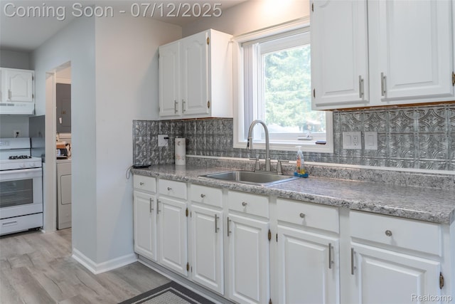 14778 Harrison St, Livonia, MI 48154 - kitchen featuring gas range gas stove, extractor fan, light wood-style flooring, backsplash, and white cabinetry
