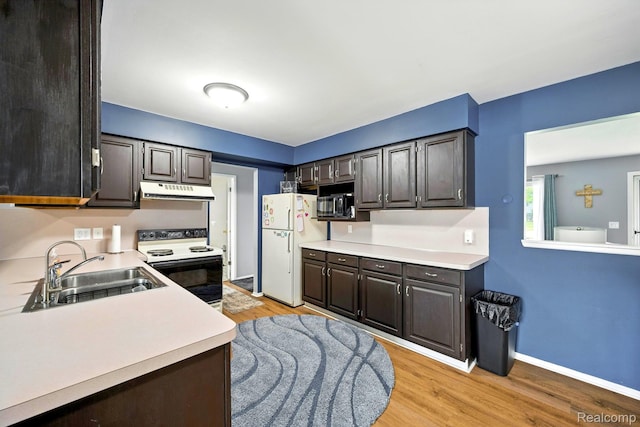 803 S Dayton St, Davison, MI 48423 - kitchen with range with electric stovetop, freestanding refrigerator, under cabinet range hood, and light countertops
