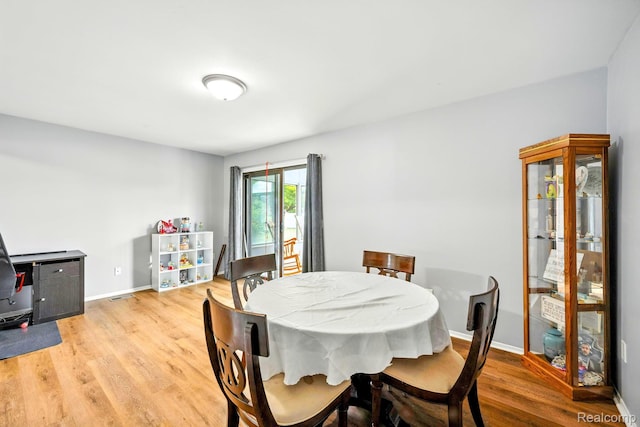 803 S Dayton St, Davison, MI 48423 - dining area with light wood-style floors and baseboards