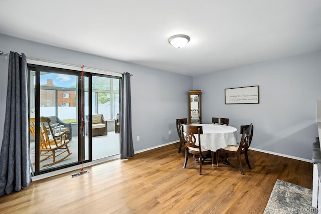803 S Dayton St, Davison, MI 48423 - dining area with light wood-style flooring and baseboards