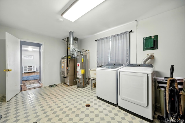 803 S Dayton St, Davison, MI 48423 - laundry room featuring water heater, washing machine and clothes dryer, light floors, and heating unit