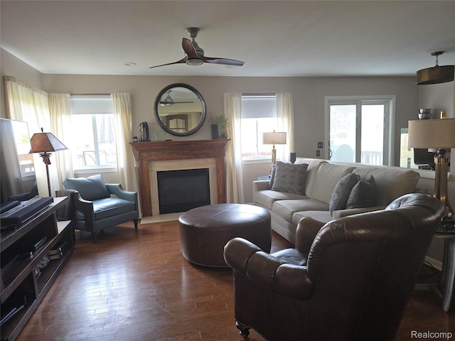 25050 Constitution Ave, Warren, MI 48089 - living area with a ceiling fan, a glass covered fireplace, and dark wood-style flooring