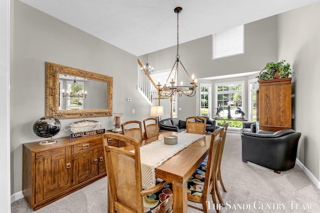 13400 Ravine View Dr, Grand Haven, MI 49417 - dining space with a chandelier, light colored carpet, and a towering ceiling