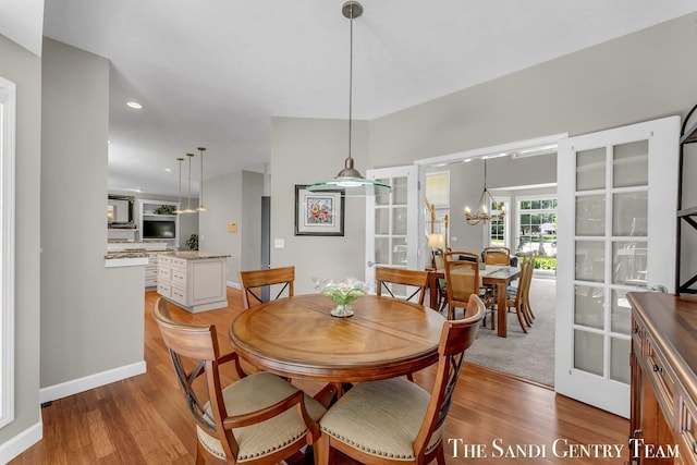 13400 Ravine View Dr, Grand Haven, MI 49417 - dining room featuring light wood-style flooring, a chandelier, and recessed lighting