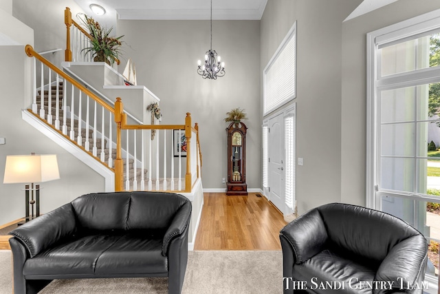 13400 Ravine View Dr, Grand Haven, MI 49417 - entryway featuring a chandelier, wood finished floors, and stairs