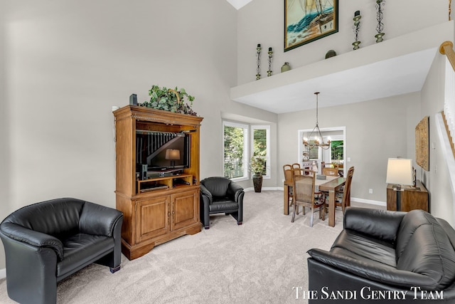 13400 Ravine View Dr, Grand Haven, MI 49417 - living area featuring light carpet, a chandelier, and a towering ceiling
