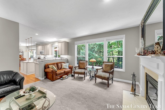 13400 Ravine View Dr, Grand Haven, MI 49417 - living area featuring healthy amount of natural light, recessed lighting, a tile fireplace, and light carpet
