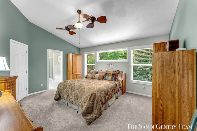 13400 Ravine View Dr, Grand Haven, MI 49417 - bedroom featuring light carpet, lofted ceiling, connected bathroom, and ceiling fan