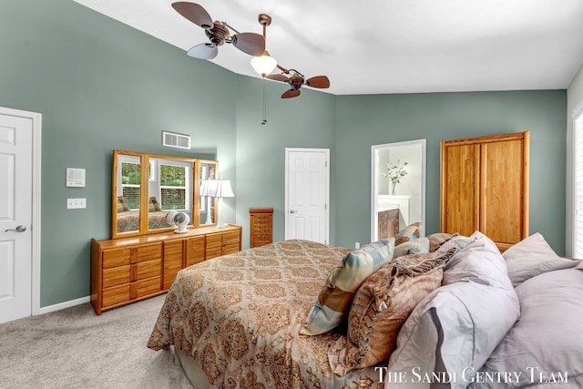 13400 Ravine View Dr, Grand Haven, MI 49417 - bedroom with light colored carpet, high vaulted ceiling, ensuite bathroom, and a ceiling fan
