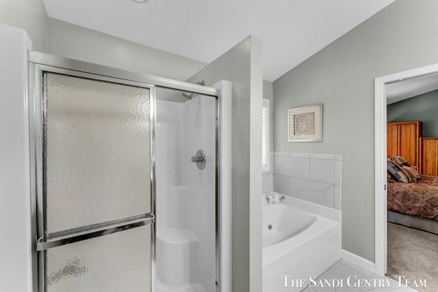 13400 Ravine View Dr, Grand Haven, MI 49417 - ensuite bathroom featuring a shower stall, a garden tub, vaulted ceiling, and tile patterned floors