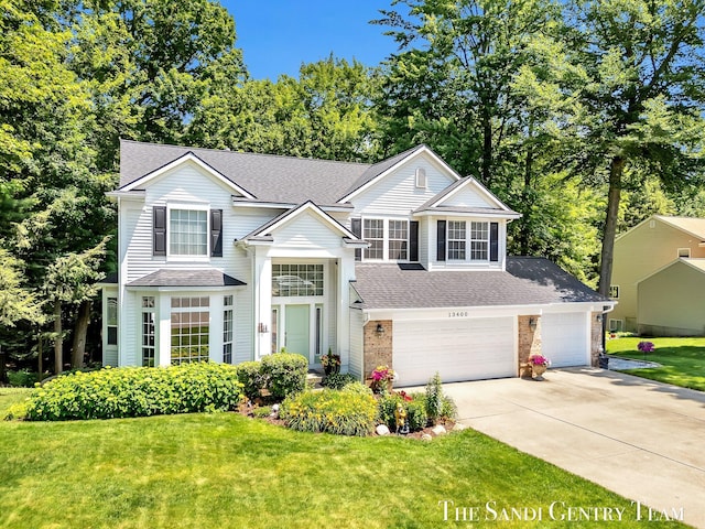 13400 Ravine View Dr, Grand Haven, MI 49417 - view of front facade with roof with shingles, concrete driveway, a front yard, and a garage