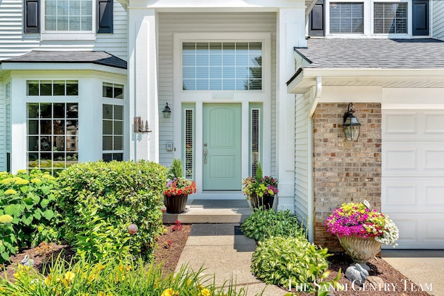 13400 Ravine View Dr, Grand Haven, MI 49417 - property entrance featuring a garage and a shingled roof