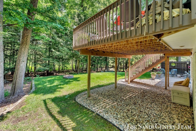 13400 Ravine View Dr, Grand Haven, MI 49417 - view of grassy yard with an outdoor fire pit, stairs, a patio area, and a wooden deck