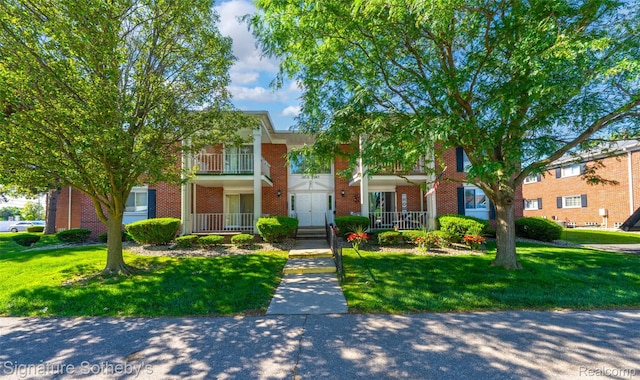 1870 Fort St Unit 1, Trenton, MI 48183 - view of property featuring brick siding and a front lawn