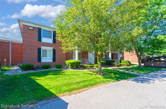 1870 Fort St Unit 1, Trenton, MI 48183 - view of front of house featuring a front lawn and brick siding
