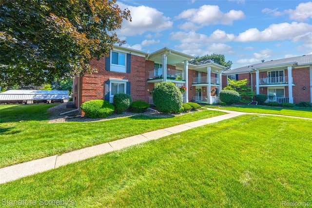1870 Fort St Unit 1, Trenton, MI 48183 - greek revival inspired property with brick siding and a front lawn