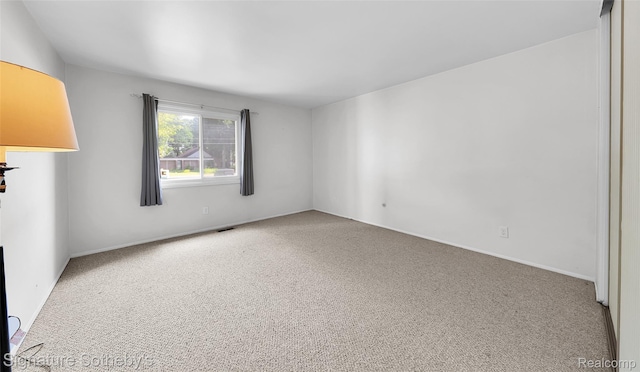 1870 Fort St Unit 1, Trenton, MI 48183 - spare room featuring carpet flooring and baseboards