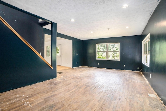 3345 Harmony Rd, Hopkins, MI 49328 - empty room featuring hardwood / wood-style flooring, a textured ceiling, and recessed lighting