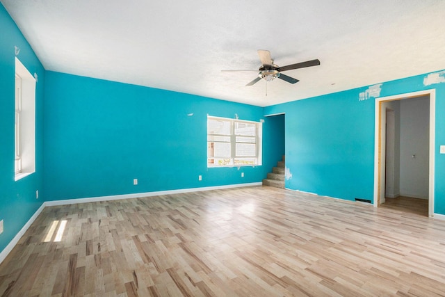 3345 Harmony Rd, Hopkins, MI 49328 - spare room with wood finished floors, a ceiling fan, and stairs