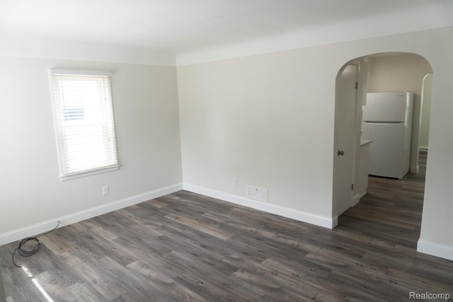 4410 Brunswick Ave, Flint, MI 48507 - spare room with arched walkways and dark wood-style flooring