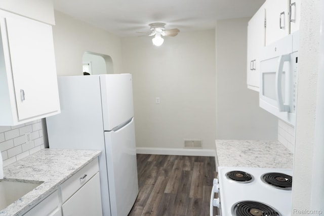 4410 Brunswick Ave, Flint, MI 48507 - kitchen featuring white appliances, backsplash, dark wood-type flooring, ceiling fan, and white cabinetry