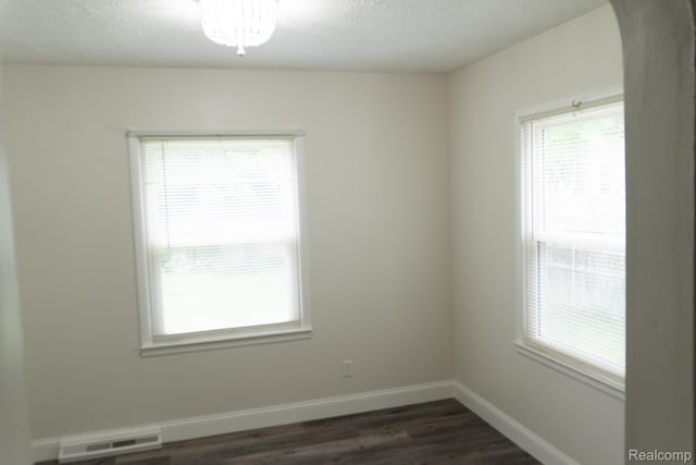 4410 Brunswick Ave, Flint, MI 48507 - unfurnished room with plenty of natural light, dark wood-type flooring, and arched walkways