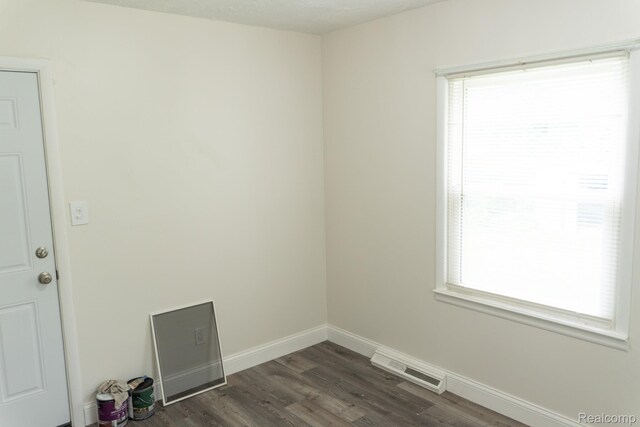 4410 Brunswick Ave, Flint, MI 48507 - unfurnished room with dark wood finished floors and baseboards