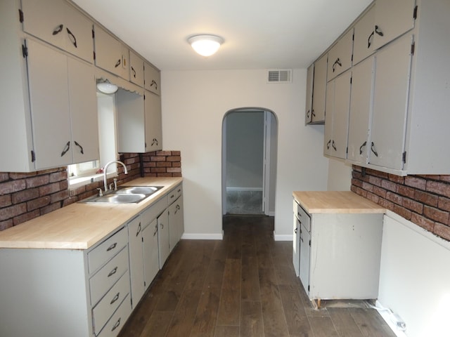 1634 Ogden Ave, Benton Harbor, MI 49022 - kitchen with tasteful backsplash, light countertops, and dark wood-style flooring