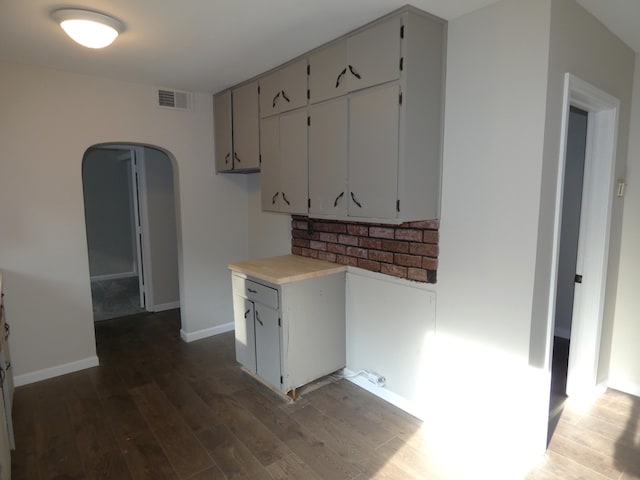 1634 Ogden Ave, Benton Harbor, MI 49022 - kitchen featuring arched walkways, dark wood-style floors, and light countertops