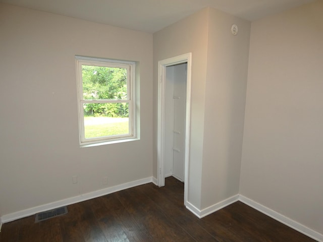 1634 Ogden Ave, Benton Harbor, MI 49022 - unfurnished bedroom featuring dark wood-style floors and baseboards