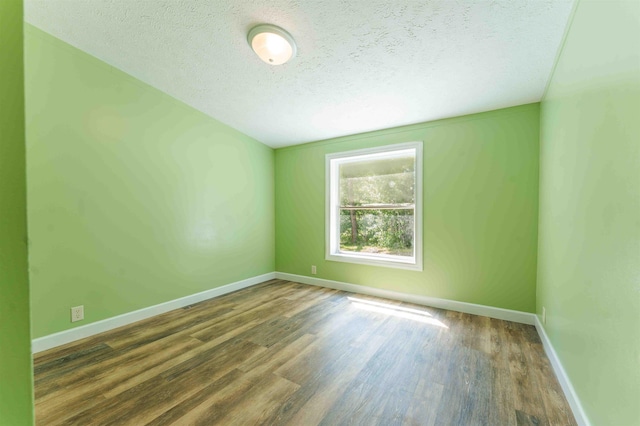 1134 Wagon Wheel Ln, Interlochen, MI 49643 - spare room featuring a textured ceiling and wood finished floors