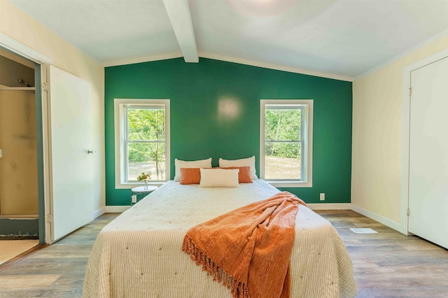 1134 Wagon Wheel Ln, Interlochen, MI 49643 - bedroom with wood finished floors and multiple windows