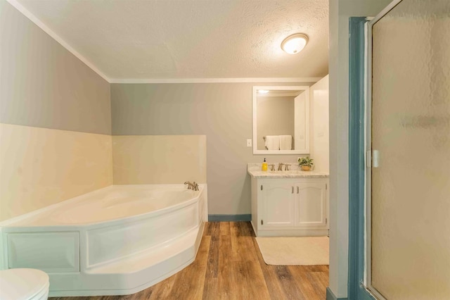 1134 Wagon Wheel Ln, Interlochen, MI 49643 - bathroom featuring wood finished floors, a stall shower, vanity, a garden tub, and a textured ceiling