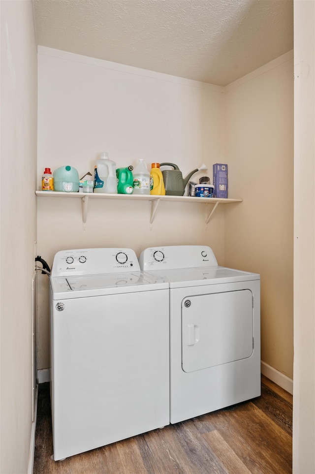 1134 Wagon Wheel Ln, Interlochen, MI 49643 - laundry area with washer and clothes dryer and wood finished floors