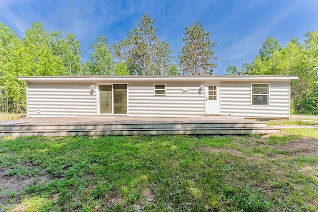 1134 Wagon Wheel Ln, Interlochen, MI 49643 - back of property featuring a wooden deck and a yard