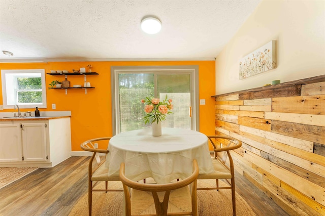 1134 Wagon Wheel Ln, Interlochen, MI 49643 - dining area featuring wood finished floors and a textured ceiling