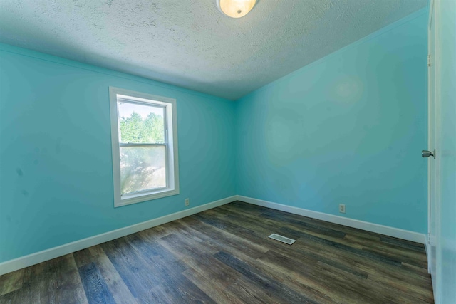 1134 Wagon Wheel Ln, Interlochen, MI 49643 - empty room with dark wood-style flooring and a textured ceiling