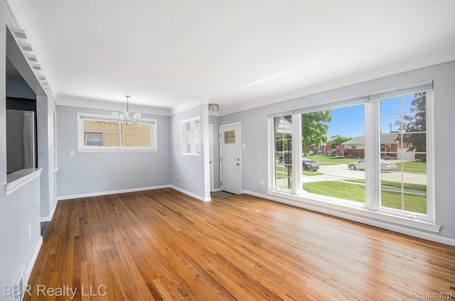 2890 Maxwell St, Trenton, MI 48183 - unfurnished living room with a chandelier and hardwood / wood-style floors