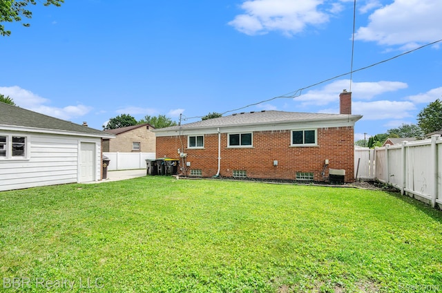 2890 Maxwell St, Trenton, MI 48183 - back of property featuring a chimney, a fenced backyard, and brick siding