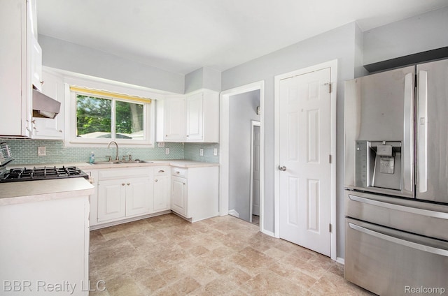 2890 Maxwell St, Trenton, MI 48183 - kitchen featuring stainless steel refrigerator with ice dispenser, decorative backsplash, light countertops, white cabinets, and stone finish floors